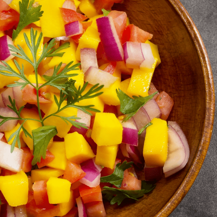 This fresh mango salsa is perfect for entertaining - the juices from the ripe mango, tomatoes and lime just mingle together, make friends and create a burst of flavours in your mouth. Serve with salmon as a main course or with tortilla chips as an appetizer. #mangosalsa #partyfood #gameday #salsa #healthypartyfood