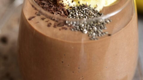 Chocolate banana smoothie with chia seed on a rustic table.