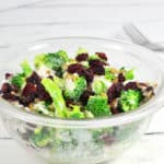 Bowl of healthy broccoli salad with fork in the background.