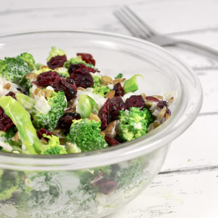 Bowl of healthy broccoli salad with fork in the background.