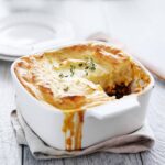A simple version of the classic meat and vegetable comfort food casserole topped with cheesy garlic mashed potatoes, this is the best Shepherd's Pie recipe you'll ever make! #easyshepherdspie #casserole #gluten-free #groundbeef