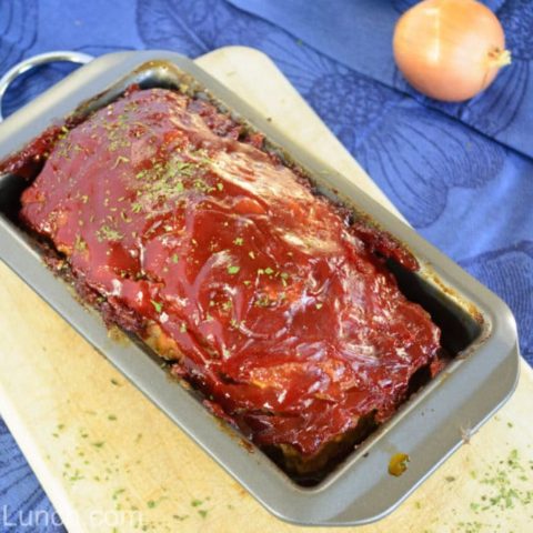 Turkey Meatloaf in loaf pan with onion