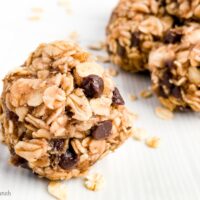 Close up of a peanut butter oate=meal banana and chocolate energy ball on a white plate