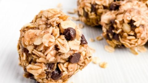 Close up of a peanut butter oate=meal banana and chocolate energy ball on a white plate