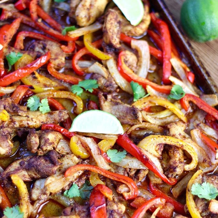 Sheet Pan Chicken Fajitas in baking pan - Is there anything better than making an entire meal on one pan? No there is not. I compiled 19 healthy sheet pan chicken recipes that make weeknight meals a breeze!