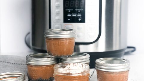 Stacked mini mason jar chocolate cheesecakes in front of an Instant Pot