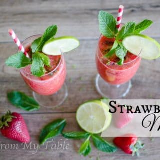 Two strawberry mojitos in stemmed glasses.