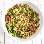 Cilantro lime chickpea salad in a white bowl on white wood countertop