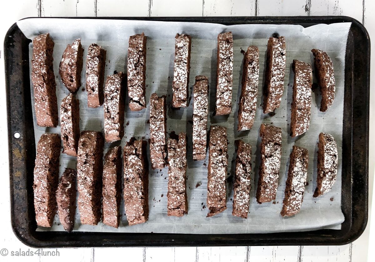 Christmas Double Chocolate Biscotti cooling on a baking sheet.