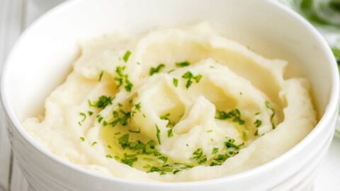 Close up of garlic parmesan mashed potatoes in a white bowl