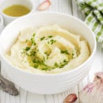 Close up of garlic parmesan mashed potatoes in a white bowl