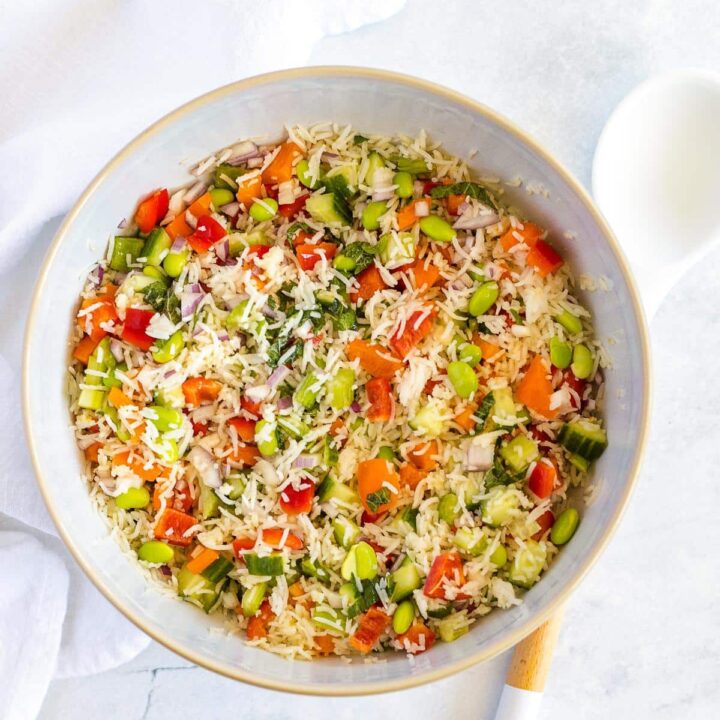 Overhead photo of a white plate with a colourful cold basmati rice salad.