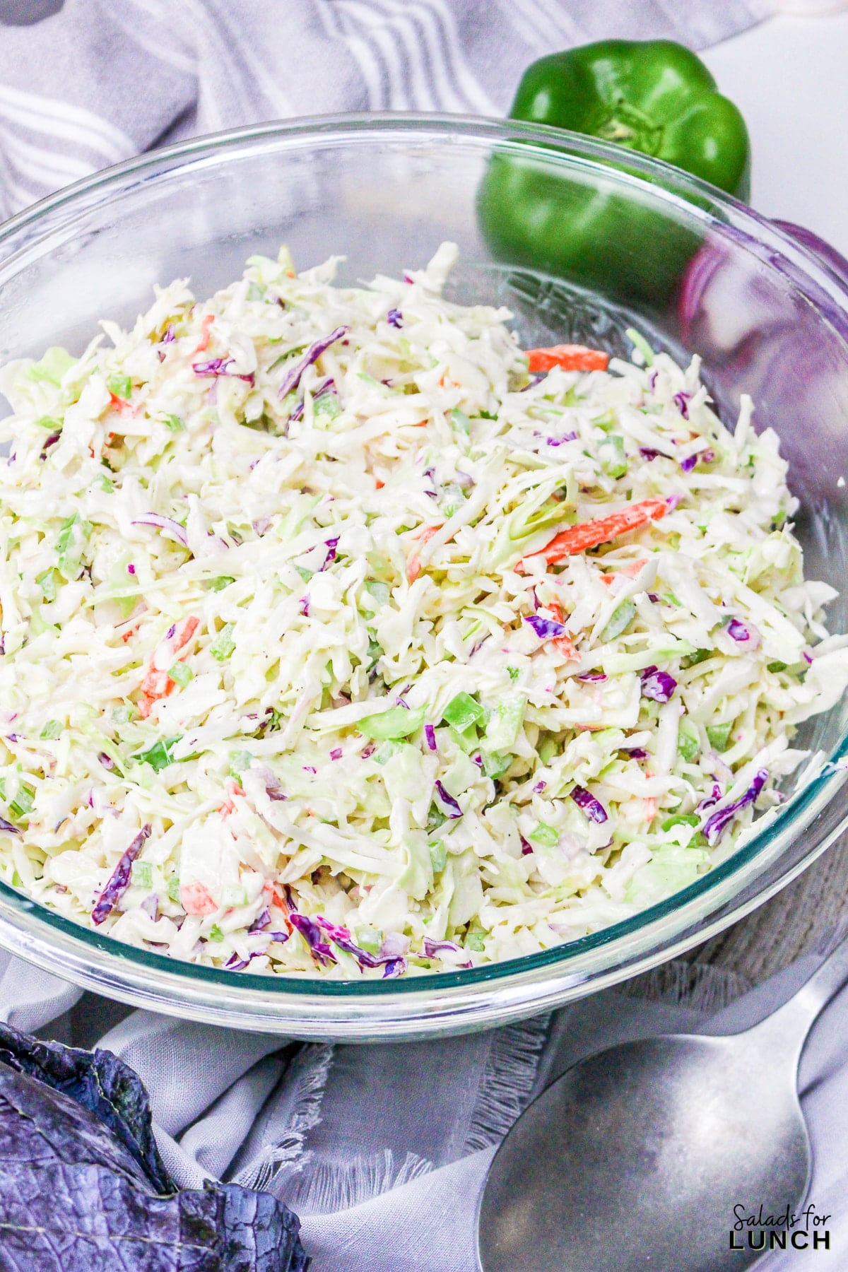 Classic coleslaw salad with mayonnaise in a glass bowl, ready for a BBQ. Creamy and crunchy!