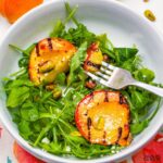 Elevate your late summer BBQ's with our elegant grilled peach salad featuring juicy peaches, peppery arugula, and crunchy pistachios in every delightful bite!