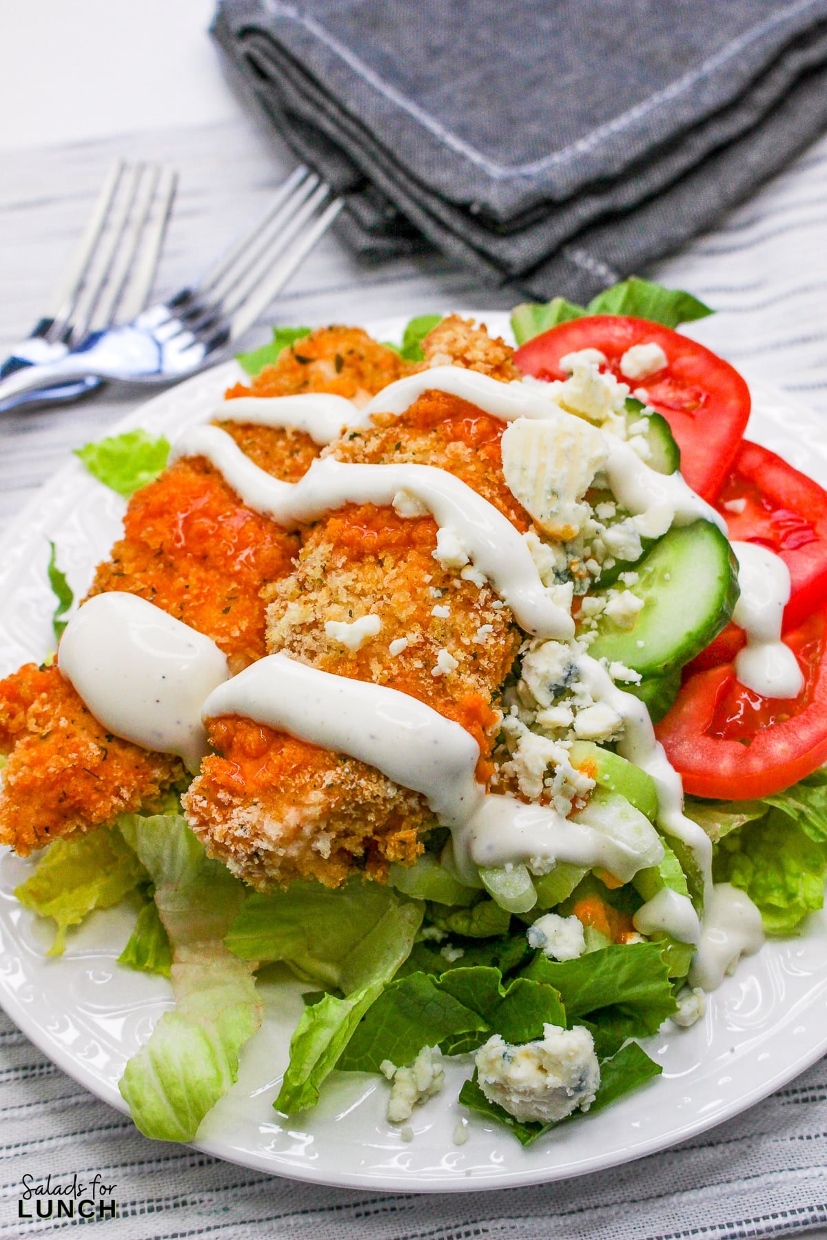 Crispy buffalo chicken salad bowl with blue cheese and ranch dressing