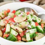 A bowl of Summer Butter Bean salad with a spoon.