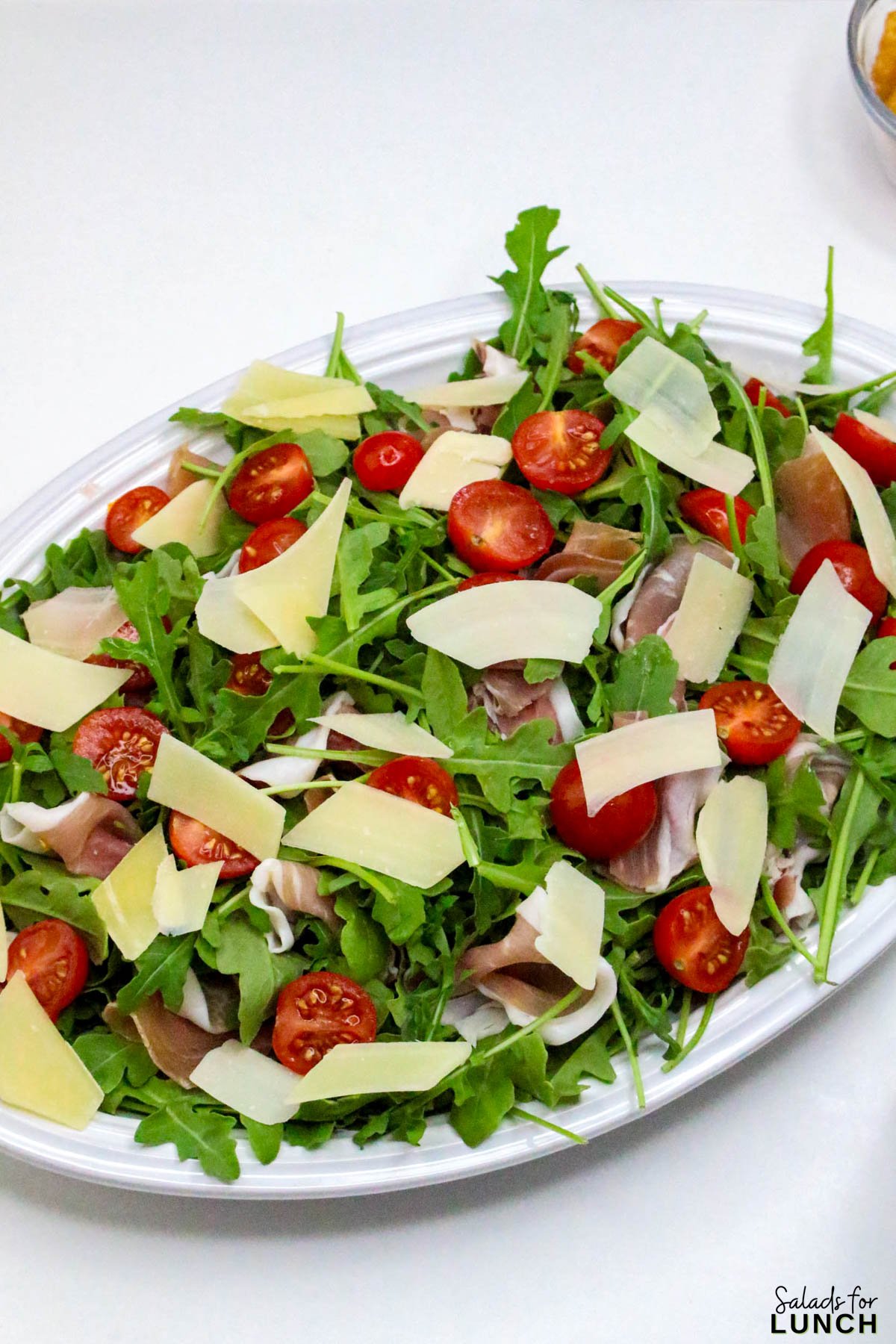 Arugula Salad with Prosciutto and Parmesan And Lemon Vinaigrette - Arugula Prusciutto Salad 12 Arugula Prusciutto Salad 12 - Try this healthy arugula salad with prosciutto, and parmesan, and a tangy lemon vinaigrette. So easy, so flavorful—your new favorite summer salad!