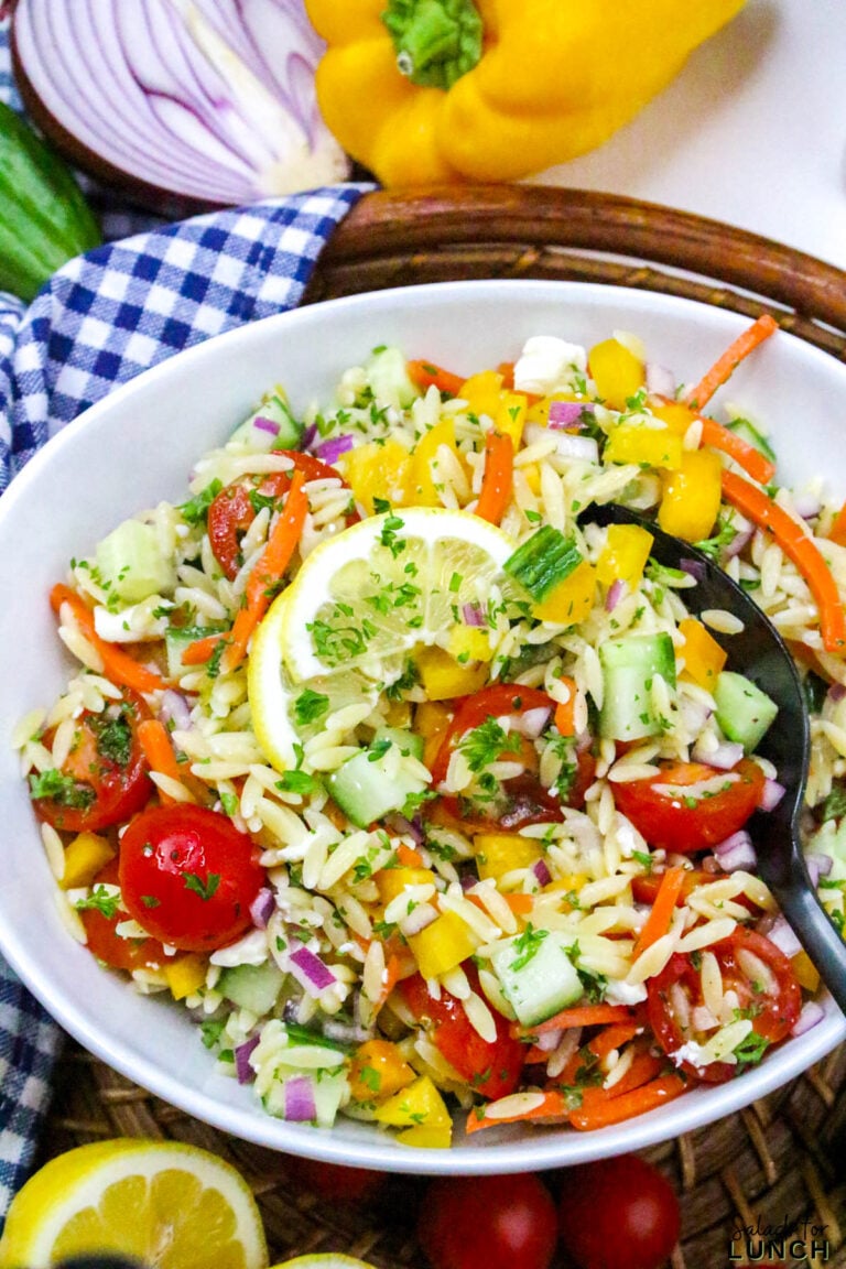 Rainbow pasta salad recipe with lemon dressing in a white bowl.