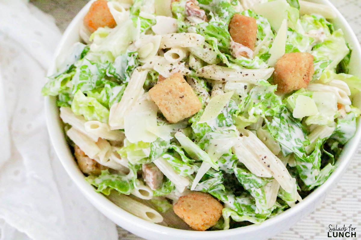 Caesar Pasta Salad Recipe 18 - If you love Caesar salad and pasta salad, then this Pasta Caesar Salad Recipe is going to be your new obsession! It’s got everything we adore about the traditional Caesar — crisp romaine, crunchy croutons, and a creamy, tangy dressing — mixed together with tender pasta for that hearty, satisfying bite. This Caesar Pasta Salad with Homemade Dressing is a total crowd-pleaser for potlucks, family dinners, or an easy weekday lunch.