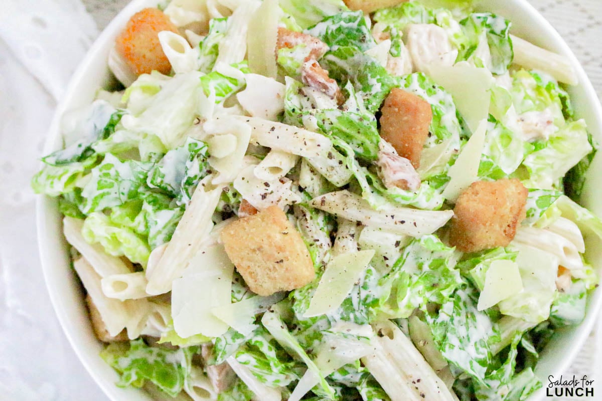 Caesar Pasta Salad Recipe 21 - If you love Caesar salad and pasta salad, then this Pasta Caesar Salad Recipe is going to be your new obsession! It’s got everything we adore about the traditional Caesar — crisp romaine, crunchy croutons, and a creamy, tangy dressing — mixed together with tender pasta for that hearty, satisfying bite. This Caesar Pasta Salad with Homemade Dressing is a total crowd-pleaser for potlucks, family dinners, or an easy weekday lunch.