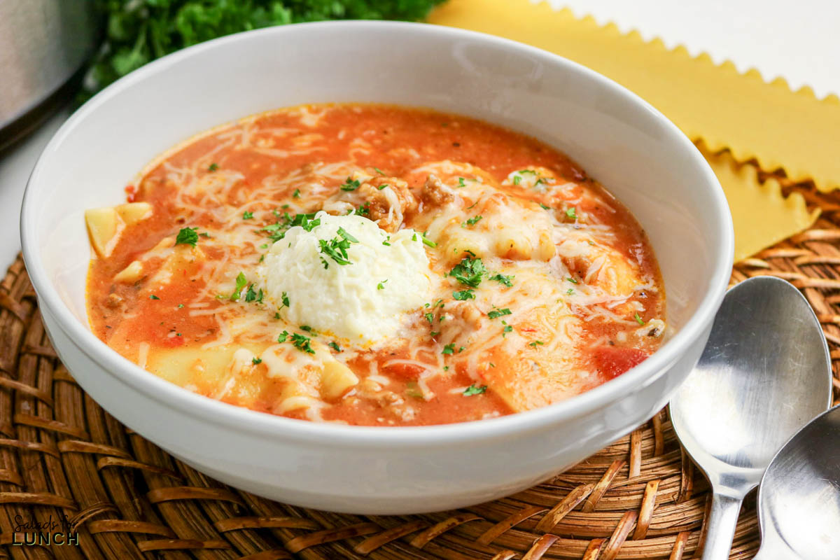 Easy Lasagna Soup Recipe 18 - Slow Cooker Lasagna Soup takes everything you crave about classic lasagna and turns it into a cozy, spoonable dinner. Think rich tomato broth, tender pasta pieces, savory meat, and melty cheese in every bite—without layering noodles or babysitting the oven. The slow cooker does the heavy lifting, making this a perfect weeknight dinner for chilly days.
