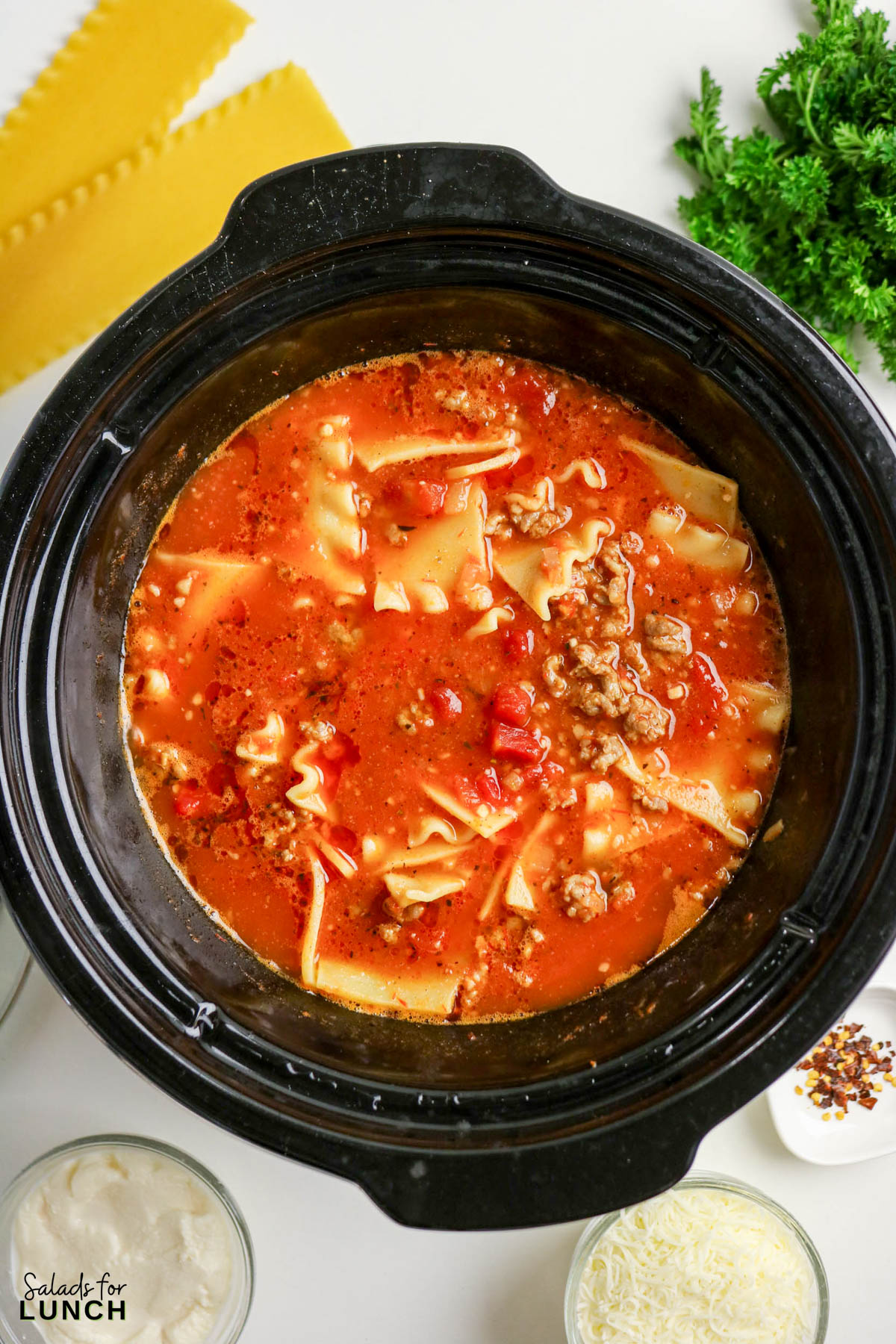 Easy Lasagna Soup Recipe 7 - Slow Cooker Lasagna Soup takes everything you crave about classic lasagna and turns it into a cozy, spoonable dinner. Think rich tomato broth, tender pasta pieces, savory meat, and melty cheese in every bite—without layering noodles or babysitting the oven. The slow cooker does the heavy lifting, making this a perfect weeknight dinner for chilly days.