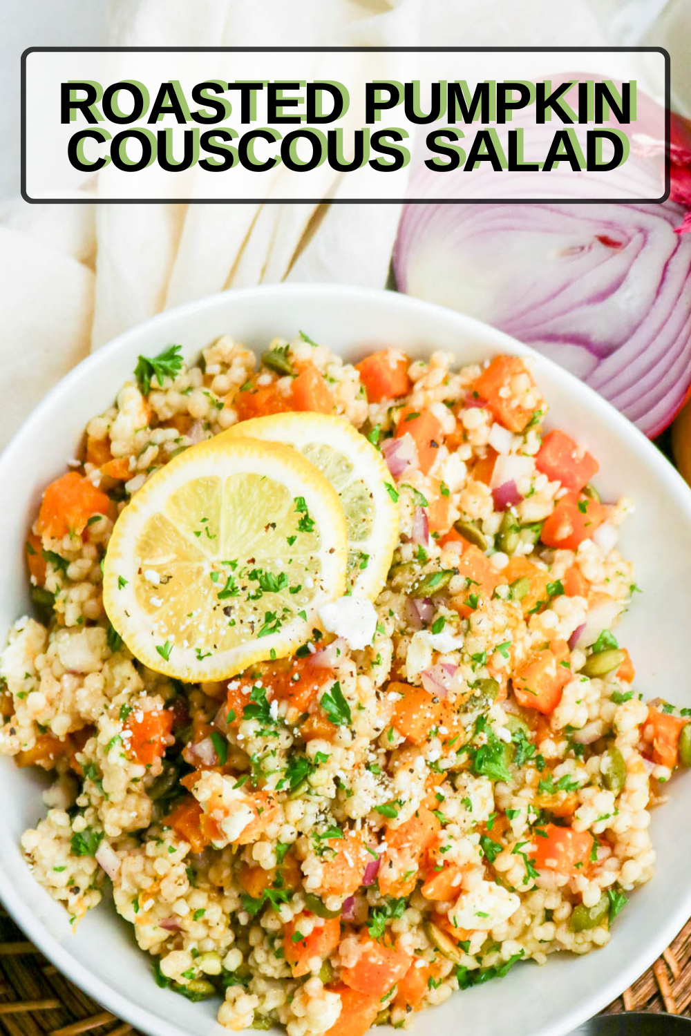 Close up of Pumpkin and Couscous Salad with a yellow lemon slice on top and text overlay that says; "Roasted Pumpkin Salad".