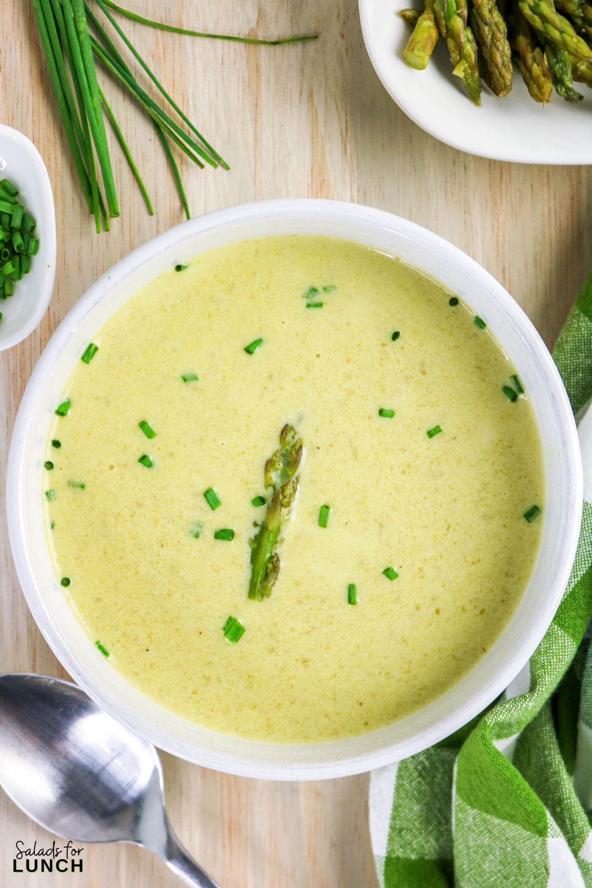 Overhead shot of Creamy Asparagus Soup in a white bowl.