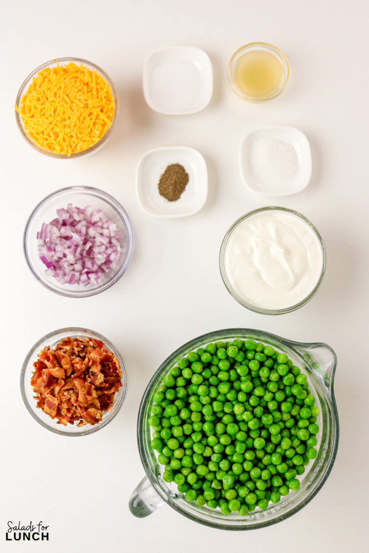 Classic Pea Salad with Bacon and Cheese (No Mayo) - Pea Salad Recipe No Mayo 01 Pea Salad Recipe No Mayo 01 - Say goodbye to heavy, overly-mayo-laden recipes, and say hello to this bright, light, and flavor-packed Classic Pea Salad. This isn’t your grandmother’s creamy classic (although we love hers too!); this version uses a light, tangy sour cream-based dressing that makes every spoonful feel fresh and wonderful. It’s the simple, cold side dish that perfectly complements any grilled chicken or baked fish.