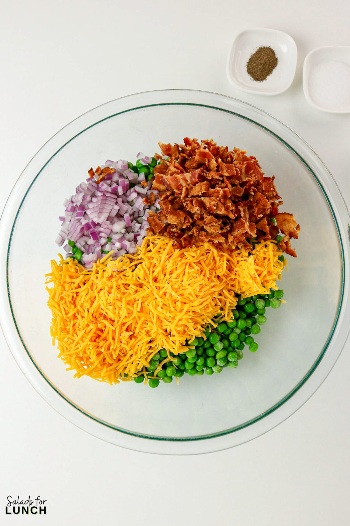 Classic Pea Salad with Bacon and Cheese (No Mayo) - Pea Salad Recipe No Mayo 02 Pea Salad Recipe No Mayo 02 - Say goodbye to heavy, overly-mayo-laden recipes, and say hello to this bright, light, and flavor-packed Classic Pea Salad. This isn’t your grandmother’s creamy classic (although we love hers too!); this version uses a light, tangy sour cream-based dressing that makes every spoonful feel fresh and wonderful. It’s the simple, cold side dish that perfectly complements any grilled chicken or baked fish.