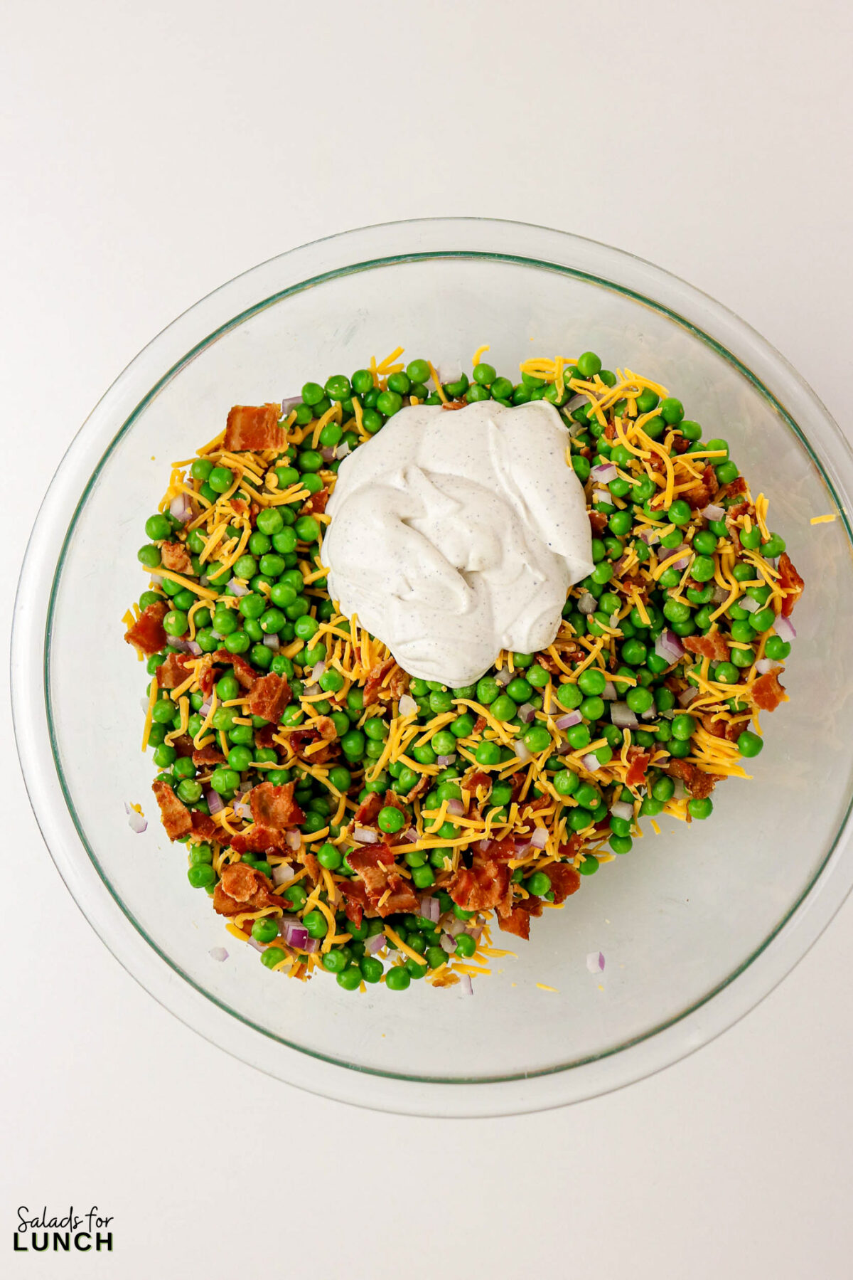 Classic Pea Salad with Bacon and Cheese (No Mayo) - Pea Salad Recipe No Mayo 06 Pea Salad Recipe No Mayo 06 - Say goodbye to heavy, overly-mayo-laden recipes, and say hello to this bright, light, and flavor-packed Classic Pea Salad. This isn’t your grandmother’s creamy classic (although we love hers too!); this version uses a light, tangy sour cream-based dressing that makes every spoonful feel fresh and wonderful. It’s the simple, cold side dish that perfectly complements any grilled chicken or baked fish.