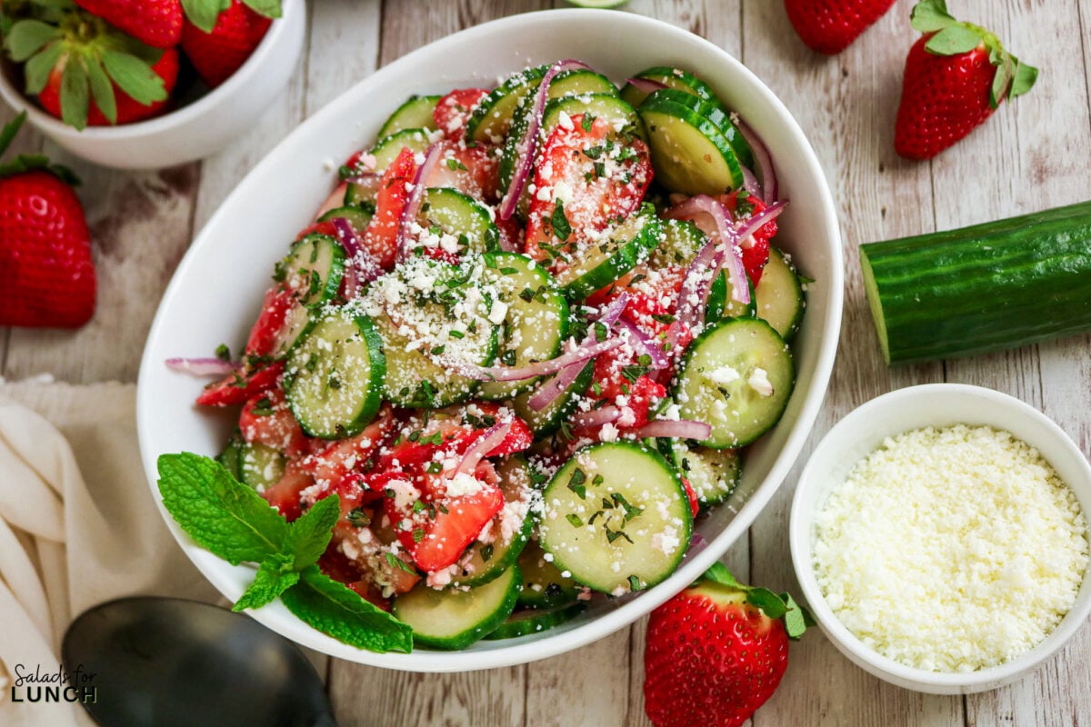 Bowl of Strawberry Cucumber Salad with Feta and Mint, garnished with fresh mint.