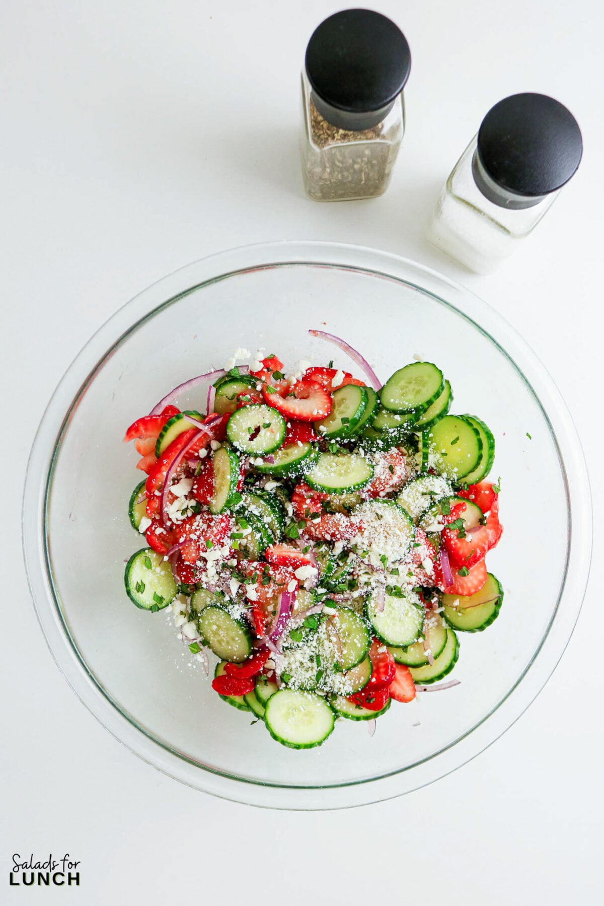 Strawberry Cucumber Salad with Feta and Mint in a glass bowl, ready to be served.