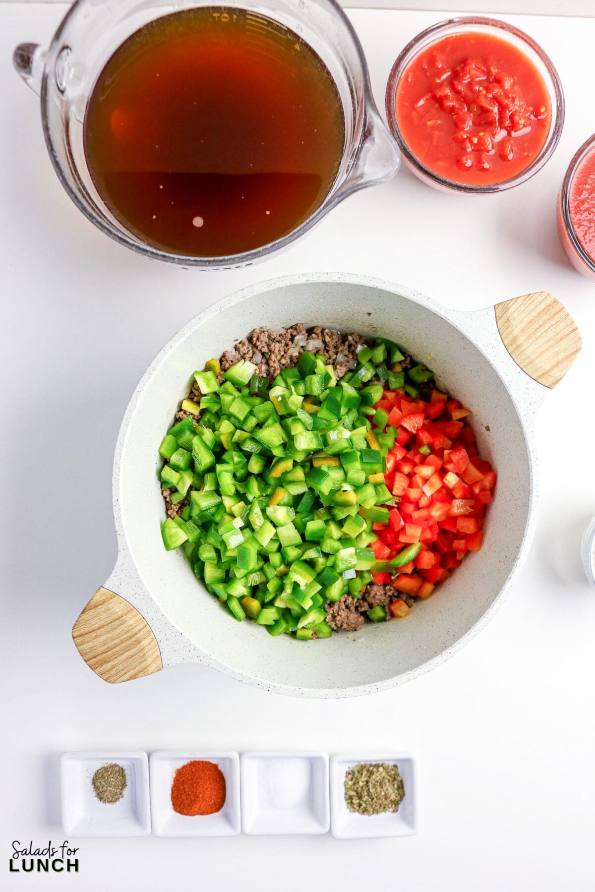 Chili ingredients: ground beef, green and red peppers, broth, diced tomatoes, and spices.