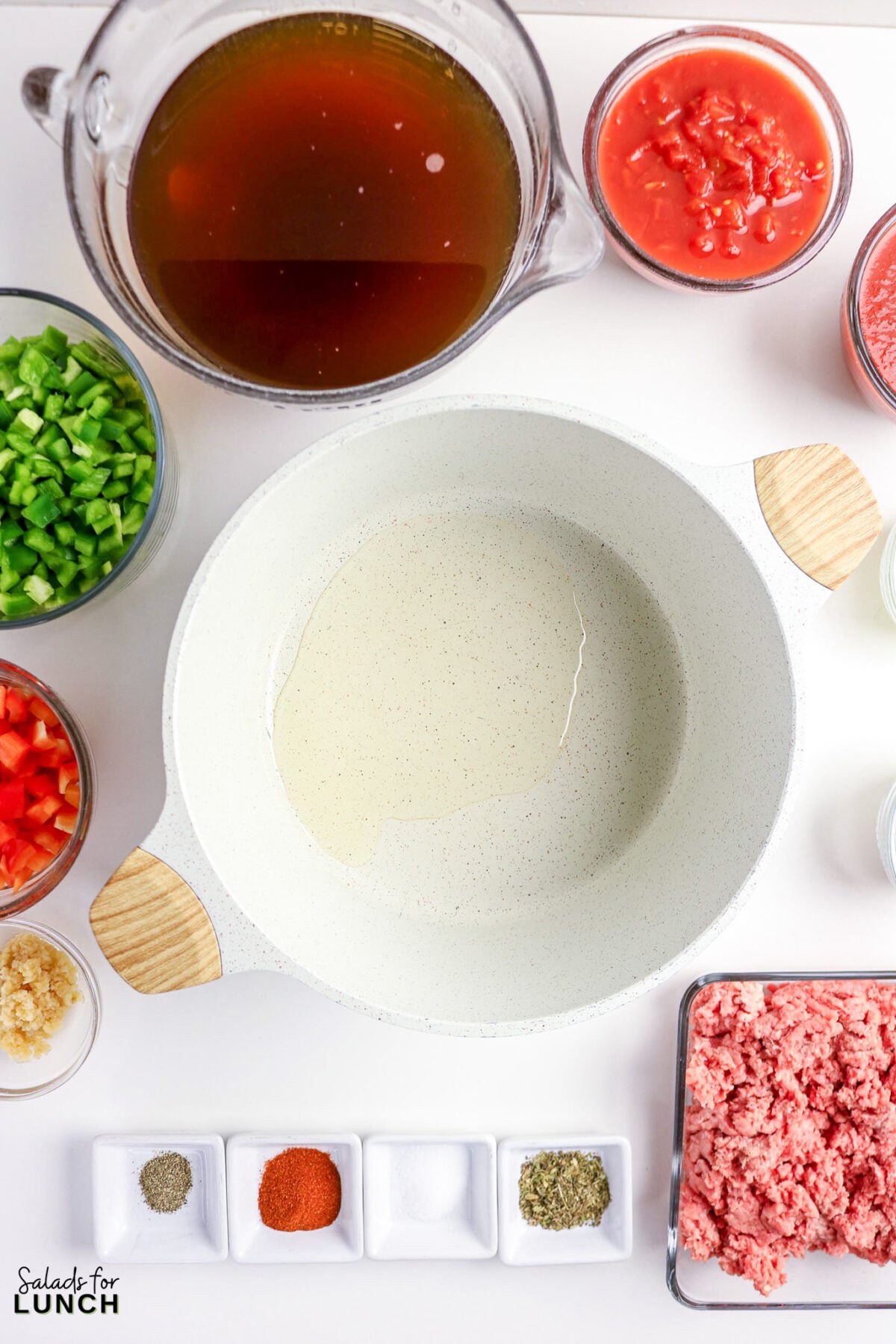 Ingredients for stuffed pepper soup: ground beef, broth, diced tomatoes, peppers, garlic, spices, and oil.