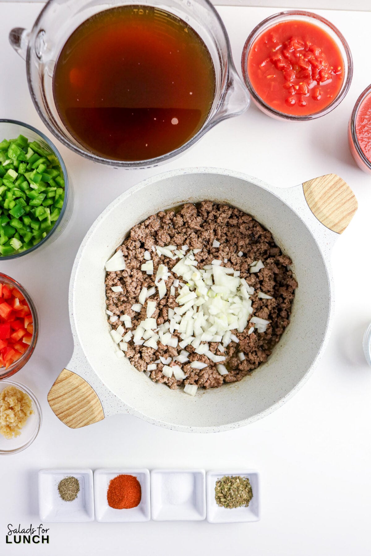 Chili ingredients: ground beef, onions, peppers, tomatoes, broth, and spices.