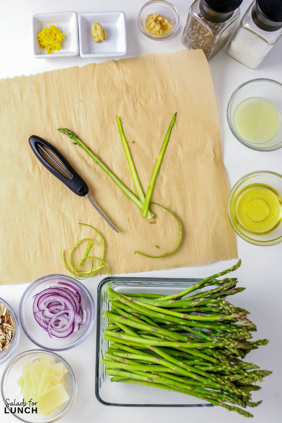 Shaved Asparagus Salad with Lemon Vinaigrette - asparagus prep salad ingredients Asparagus prep: trimming, lemon zest, garlic, oil, and red onion for a salad