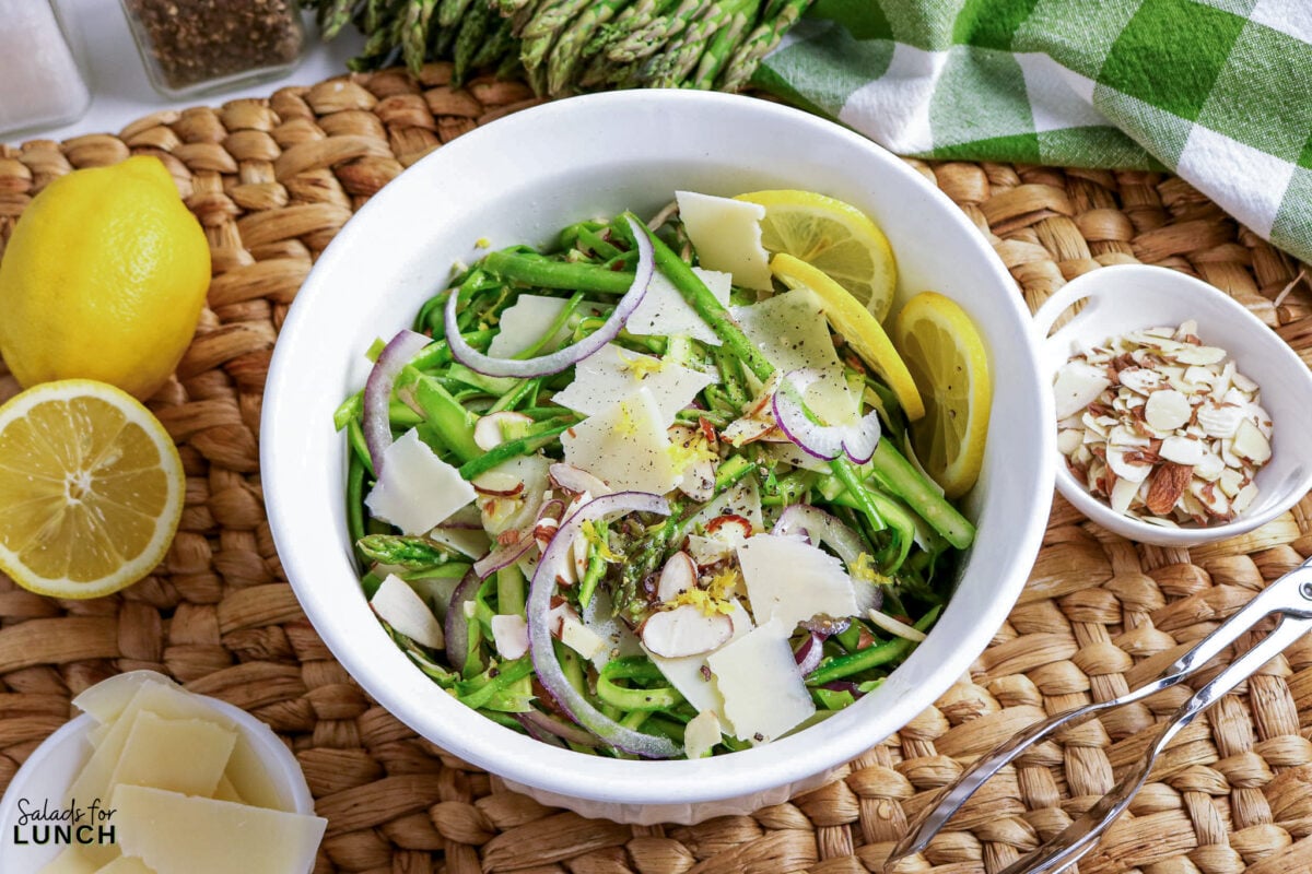 Shaved Asparagus Salad with Lemon Vinaigrette - asparagus shaved parmesan salad 2 Asparagus salad with shaved parmesan, red onion, almonds, and lemon slices.