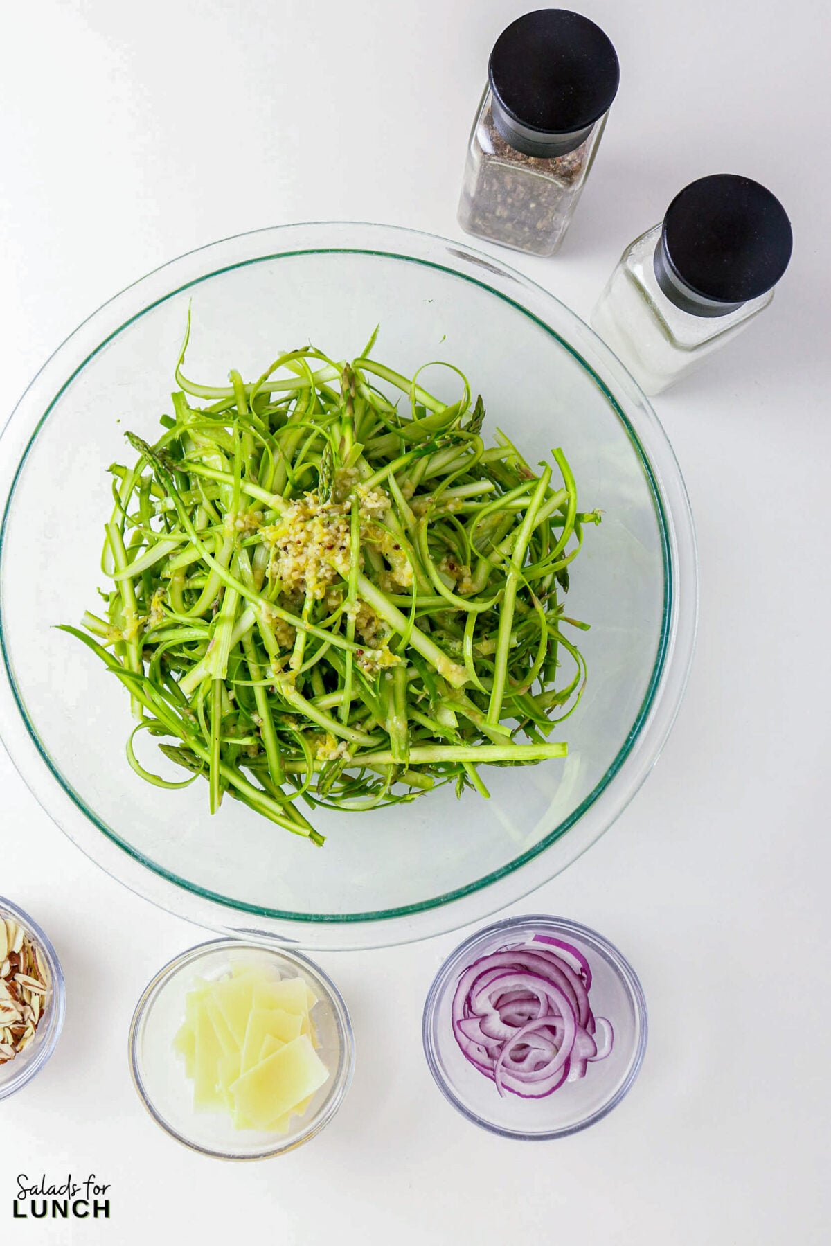 Shaved Asparagus Salad with Lemon Vinaigrette - shaved asparagus salad ingredients 1 Shaved asparagus salad with almonds, red onion, and shaved parmesan.