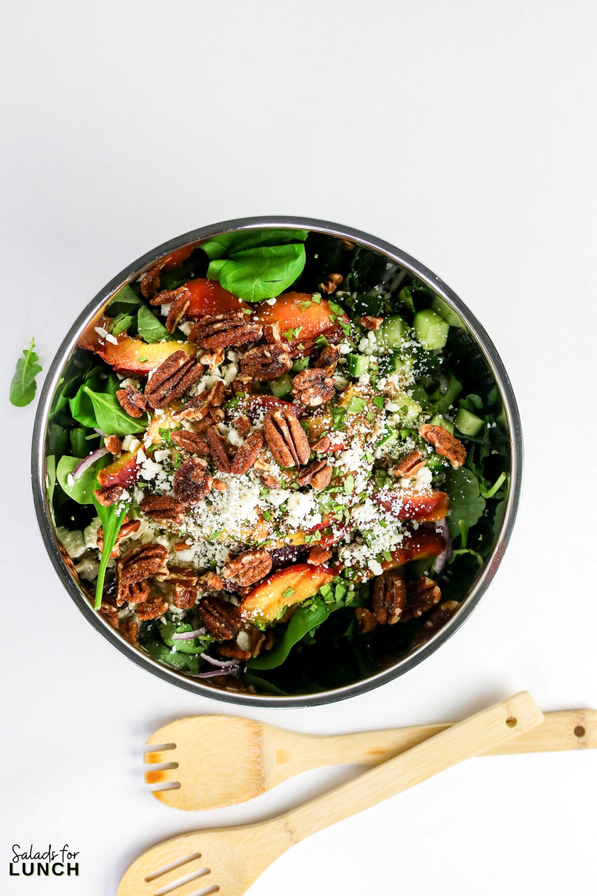 Grilled Peaches Quinoa Salad 18 - This Grilled Peach Quinoa Salad is a hearty, colorful salad bowl that comes together in about 40 minutes and earns a spot at every cookout, potluck, and lazy weekend lunch. Smoky grilled peaches, fluffy quinoa, crisp cucumber, peppery arugula, creamy feta, and crunchy toasted nuts all get tied together with a tangy honey-lemon dressing.