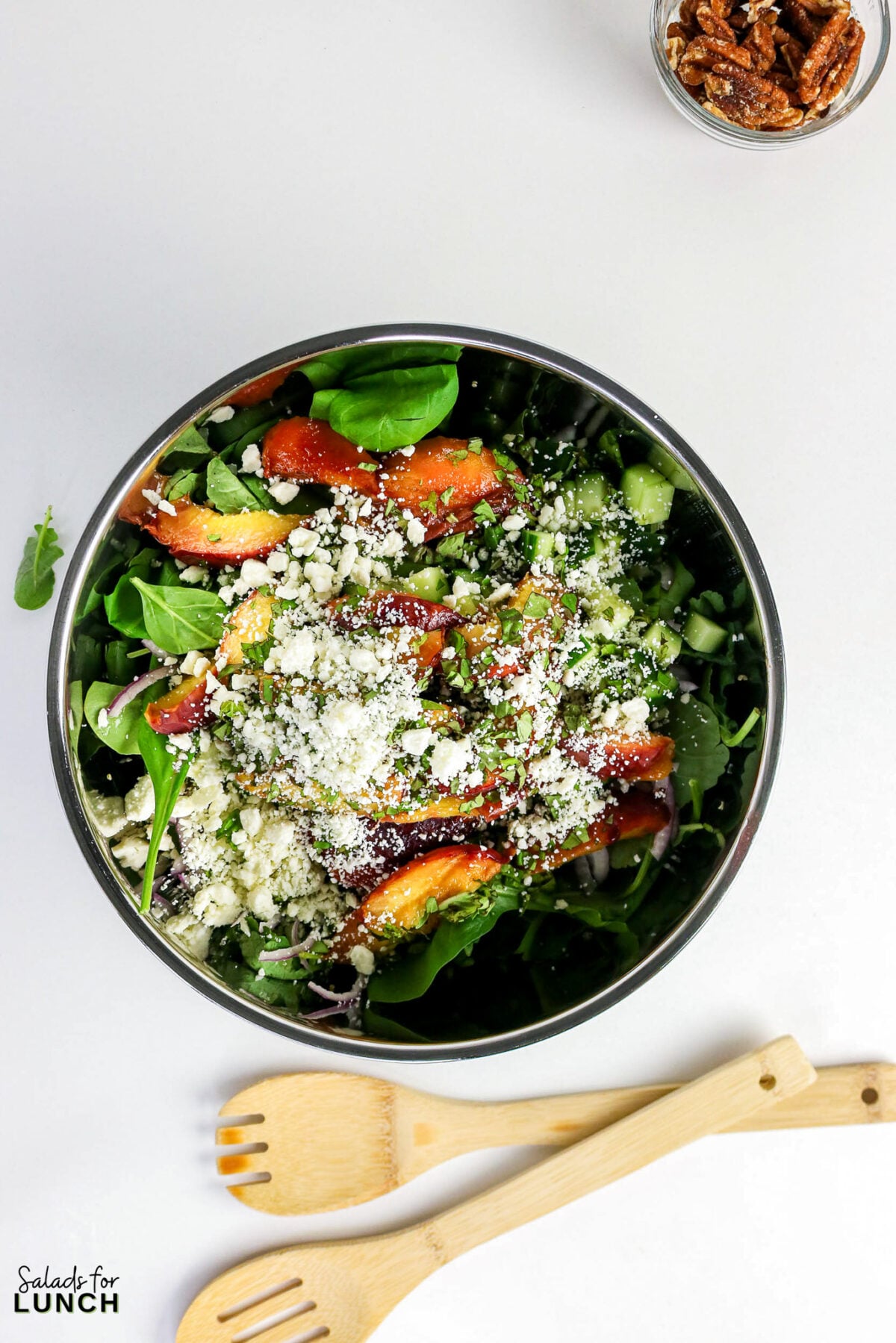 Grilled Peaches Quinoa Salad 19 - This Grilled Peach Quinoa Salad is a hearty, colorful salad bowl that comes together in about 40 minutes and earns a spot at every cookout, potluck, and lazy weekend lunch. Smoky grilled peaches, fluffy quinoa, crisp cucumber, peppery arugula, creamy feta, and crunchy toasted nuts all get tied together with a tangy honey-lemon dressing.