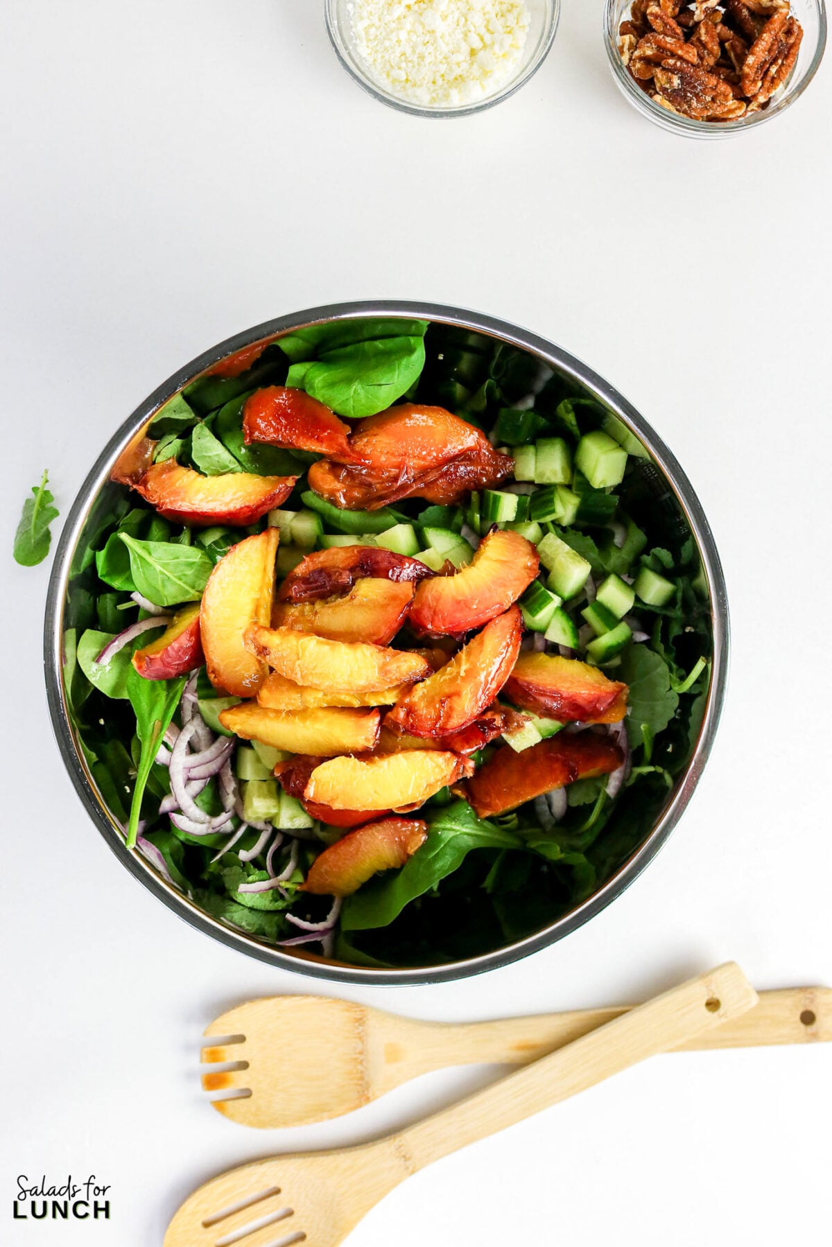 Grilled Peaches Quinoa Salad 21 - This Grilled Peach Quinoa Salad is a hearty, colorful salad bowl that comes together in about 40 minutes and earns a spot at every cookout, potluck, and lazy weekend lunch. Smoky grilled peaches, fluffy quinoa, crisp cucumber, peppery arugula, creamy feta, and crunchy toasted nuts all get tied together with a tangy honey-lemon dressing.