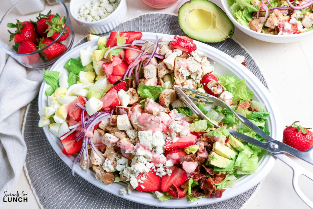 Strawberry Chicken Cobb Salad with Creamy Strawberry Vinaigrette - chicken strawberry salad avocado blue cheese Chicken strawberry salad with avocado, blue cheese, and bacon, drizzled with dressing.