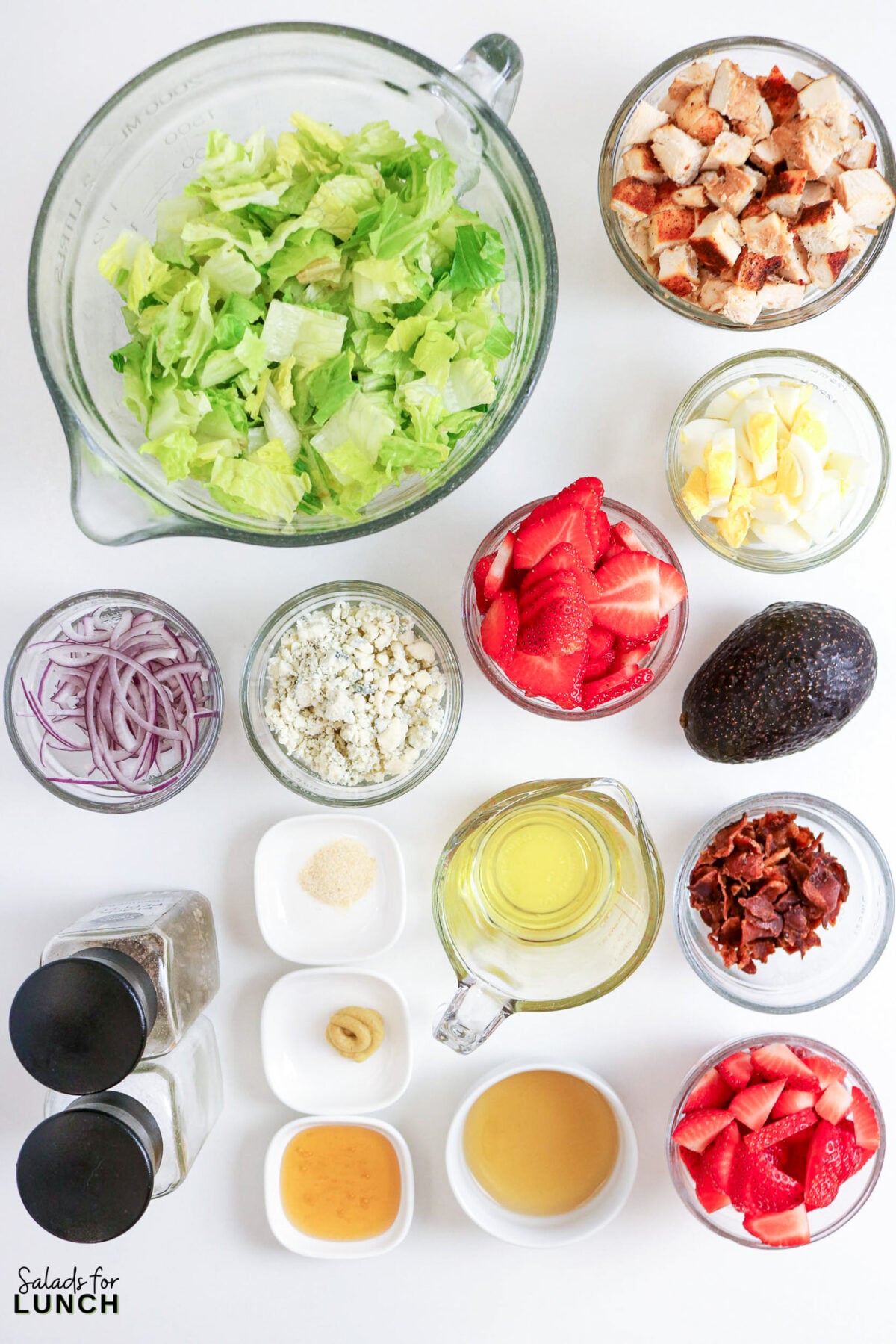 Strawberry Chicken Cobb Salad with Creamy Strawberry Vinaigrette - strawberry chicken salad ingredients Strawberry chicken salad ingredients laid out on a white surface.