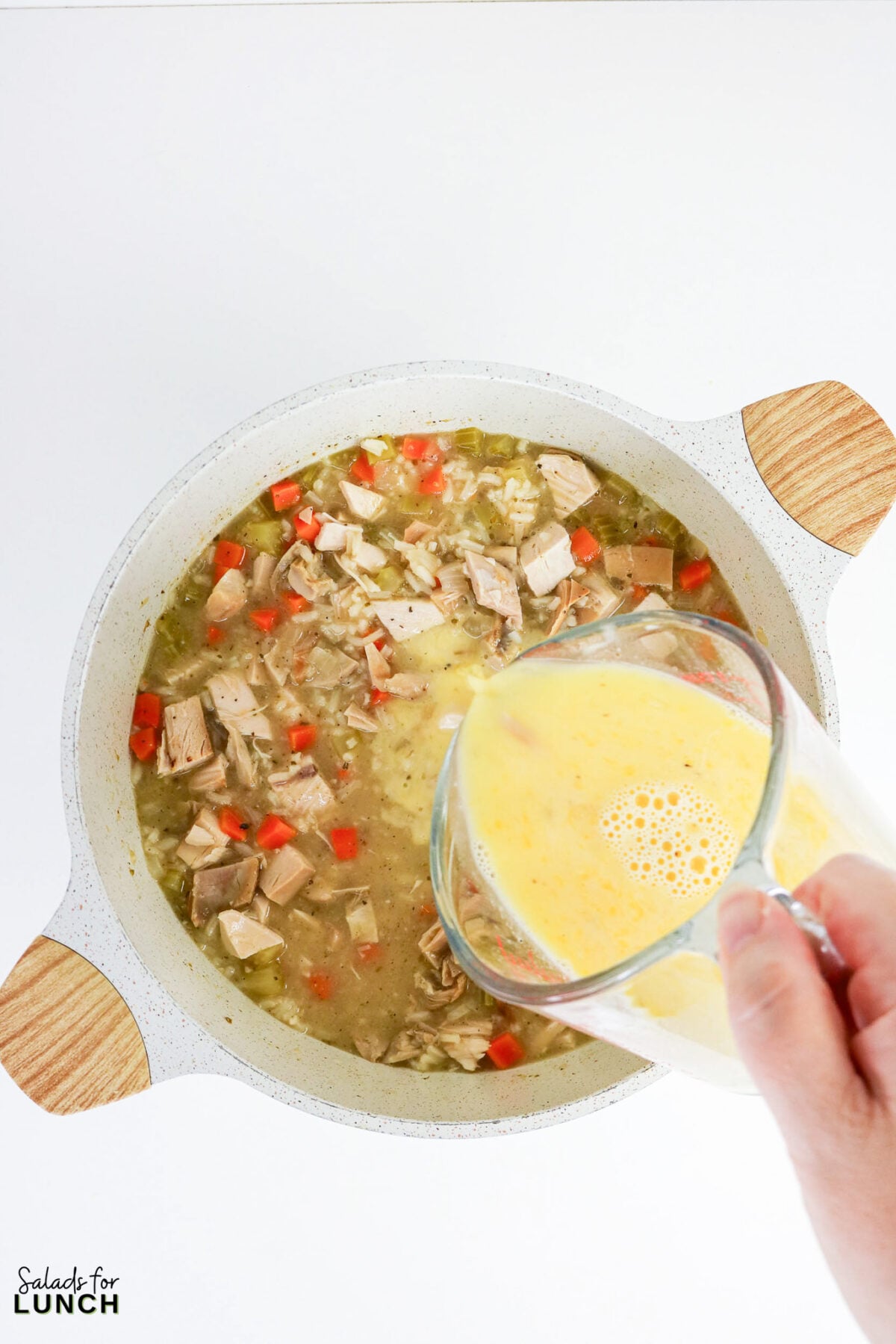 Greek Lemon Chicken and Rice Soup (Easy Avgolemono Recipe) - Greek Lemon Chicken Soup with Rice Recipe 28 Instructional step image showing a specific technique (tempering eggs into soup).
