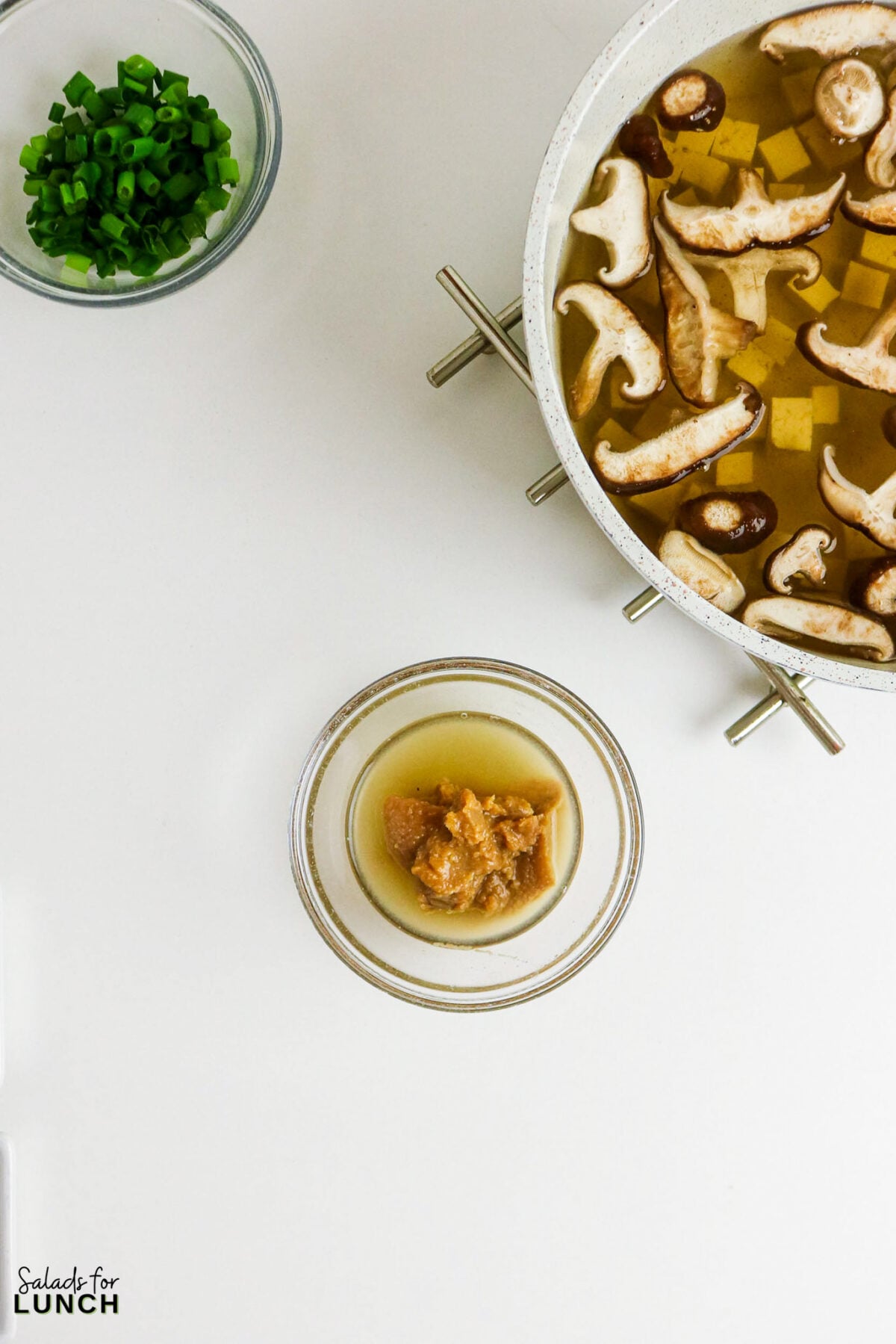Easy Miso Soup with Mushrooms - Miso Soup Recipe With Mushrooms 27 Miso paste dissolved in a small bowl of hot broth, ready to be stirred into the pot of mushrooms and tofu.