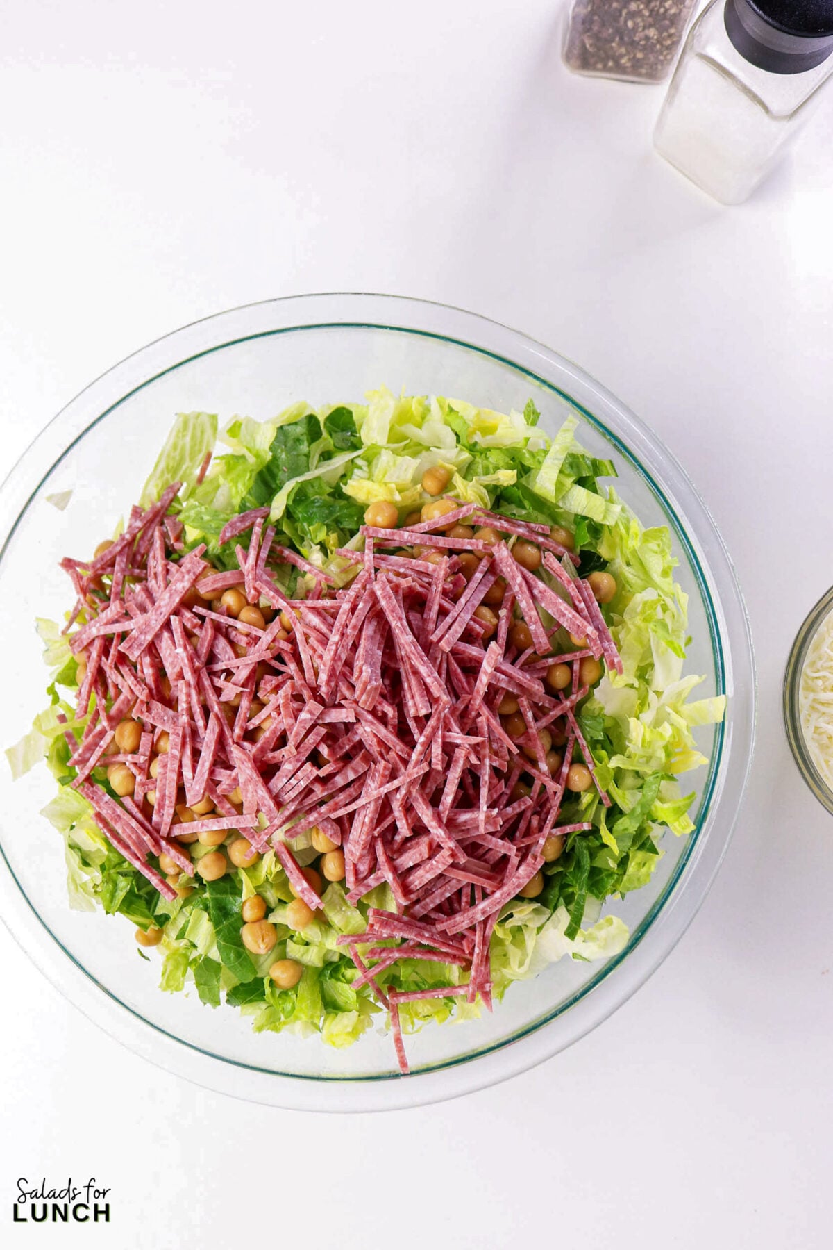 La Scala Chopped Salad Recipe (Easy Beverly Hills Copycat) - Process La Scala Italian Chopped Salad 5 Process La Scala Italian Chopped Salad 5 - This Italian-inspired chopped salad is crisp and flavorful, combining crunchy iceberg and romaine with savory salami, tender chickpeas, and creamy mozzarella tossed in a tangy red wine vinaigrette. It's a restaurant-style salad that's easy to make at home and works as a light lunch or party side.