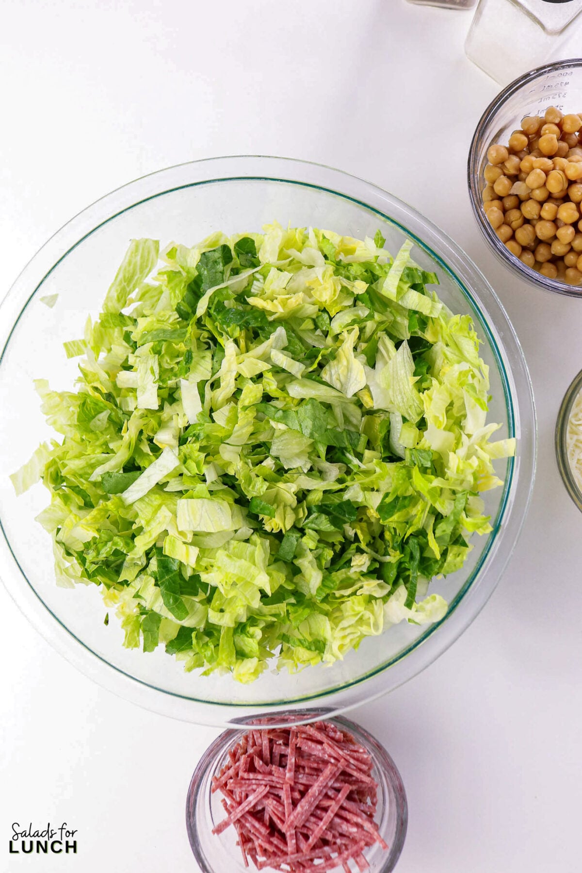 La Scala Chopped Salad Recipe (Easy Beverly Hills Copycat) - Process La Scala Italian Chopped Salad 6 Process La Scala Italian Chopped Salad 6 - This Italian-inspired chopped salad is crisp and flavorful, combining crunchy iceberg and romaine with savory salami, tender chickpeas, and creamy mozzarella tossed in a tangy red wine vinaigrette. It's a restaurant-style salad that's easy to make at home and works as a light lunch or party side.