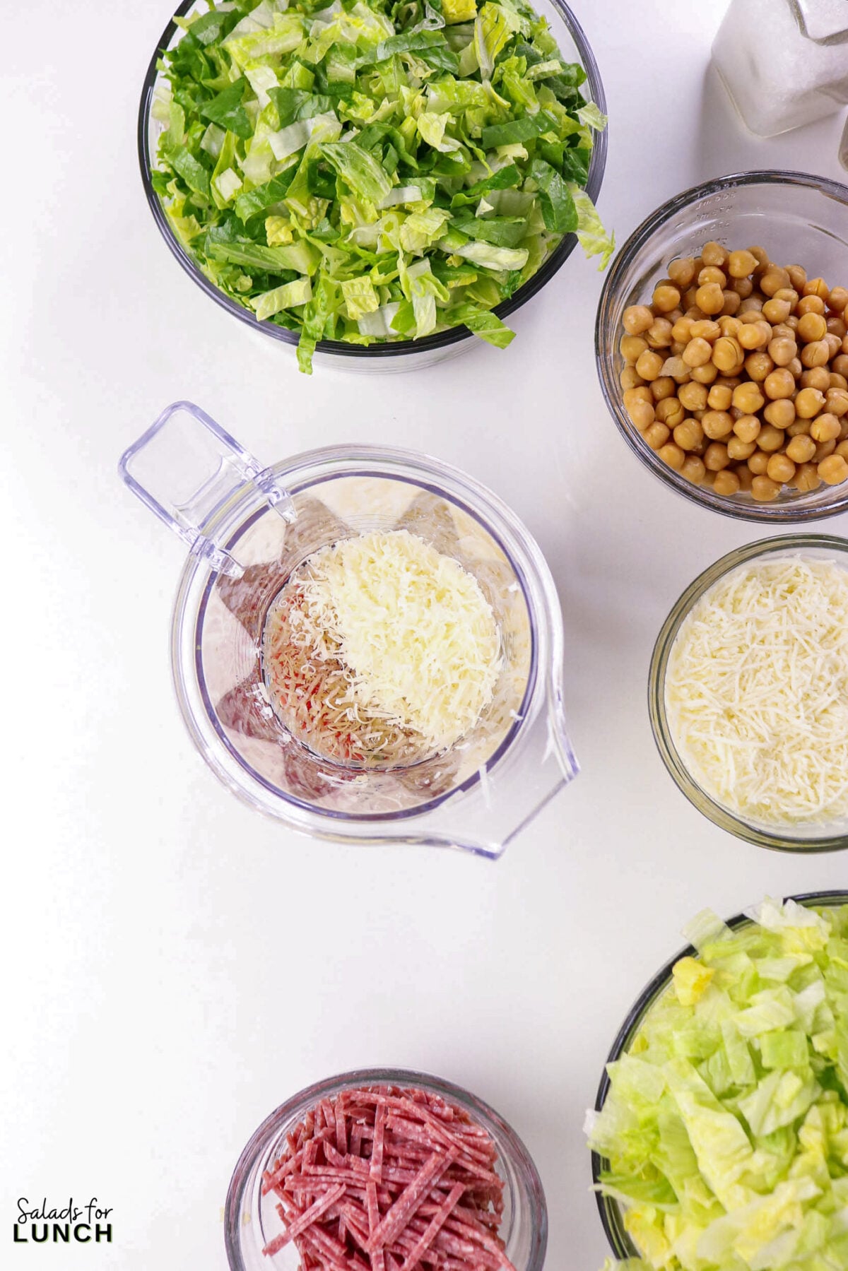 La Scala Chopped Salad Recipe (Easy Beverly Hills Copycat) - Process La Scala Italian Chopped Salad 7 Salad ingredients in separate bowls: chopped romaine, chickpeas, shredded Mozzarella, sliced salami, and dressing in a blender jar.