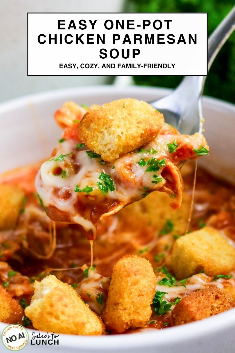One-Pot Chicken Parmesan Soup - Easy One Pot Chicken Parmesan Soup 1 Bowl of Chicken Parmesan Soup with melted mozzarella, tomato broth, and croutons on a spoon.